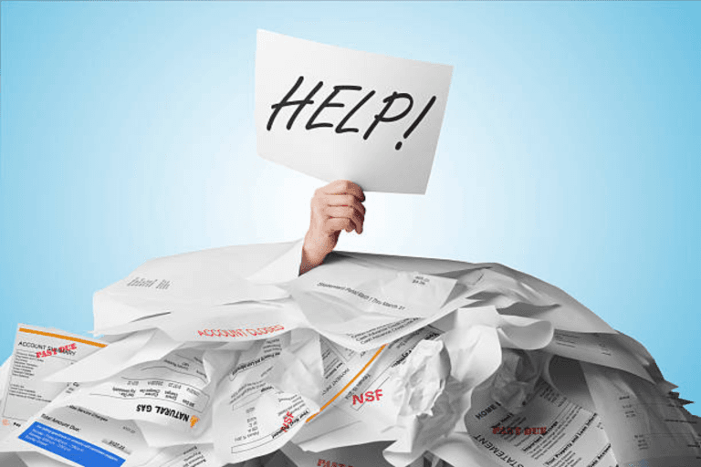 A hand holding up a paper with 'HELP!' written on it.